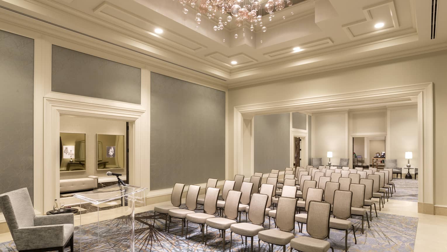 Palm Ballroom Foyer conference with rows of chairs facing plush armchair 