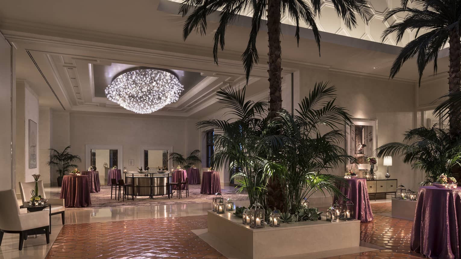 Grand Ballroom Foyer with potted palm trees and candles, cocktail lounge tables under light