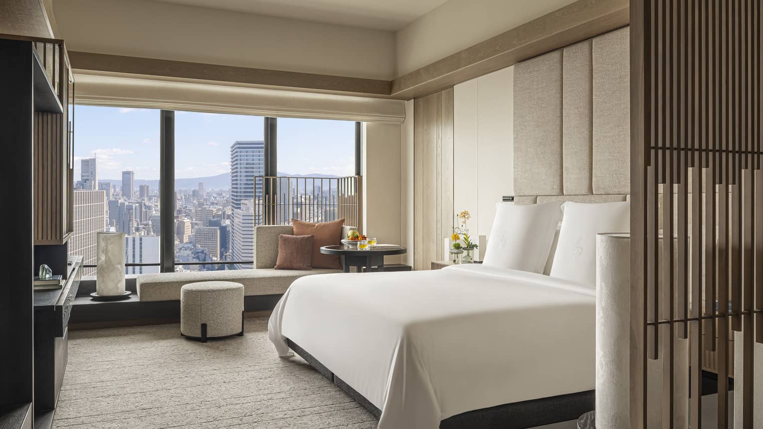 Hotel room with king bed and Osaka city view