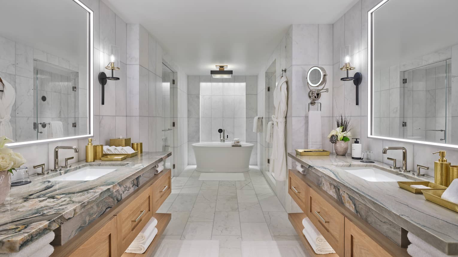 Large marble bathroom, with a vanity on each side and a standalone tub