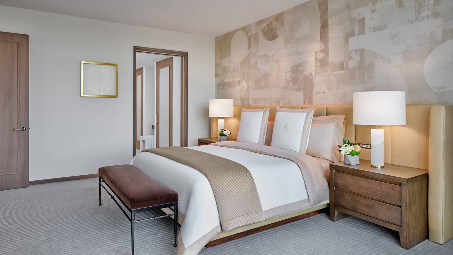 Bedroom with king bed, accent wall, bedside tables and lamps
