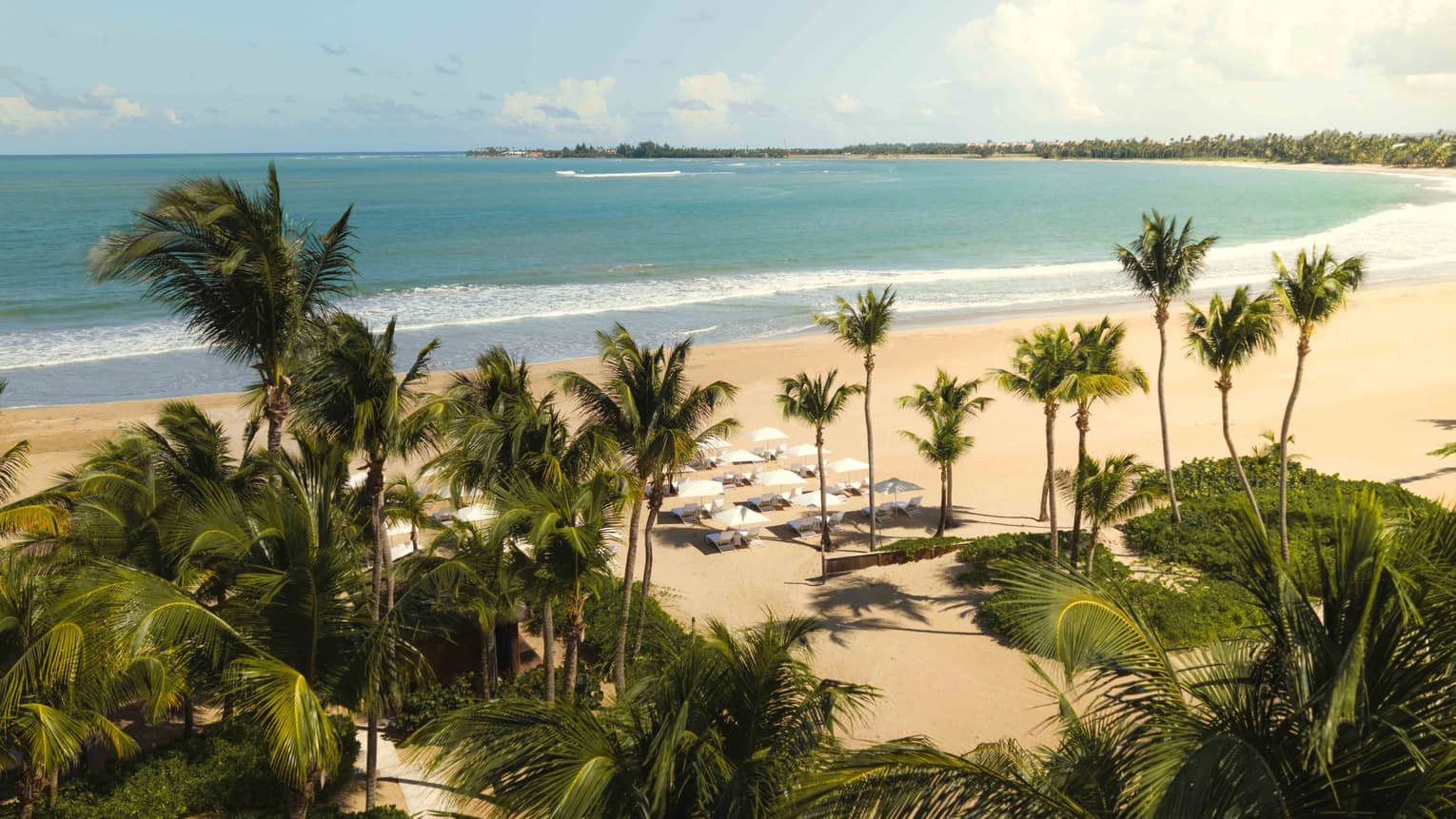 Tropical crescent-shaped, white-sand beach