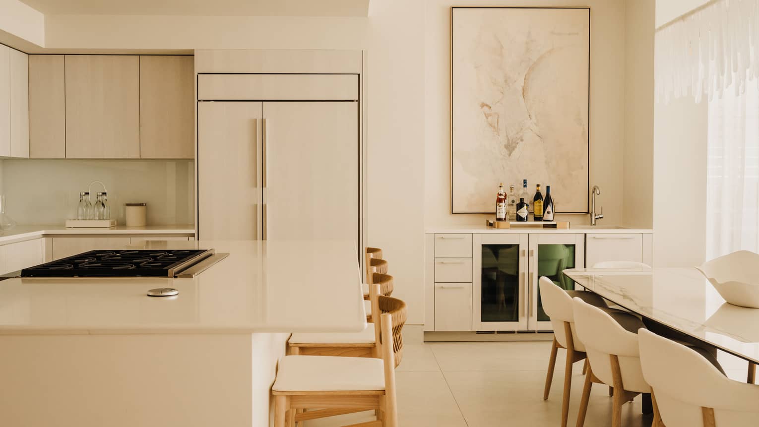 Luxury modern kitchen with counter seating at the island, and a dining table with eight chairs