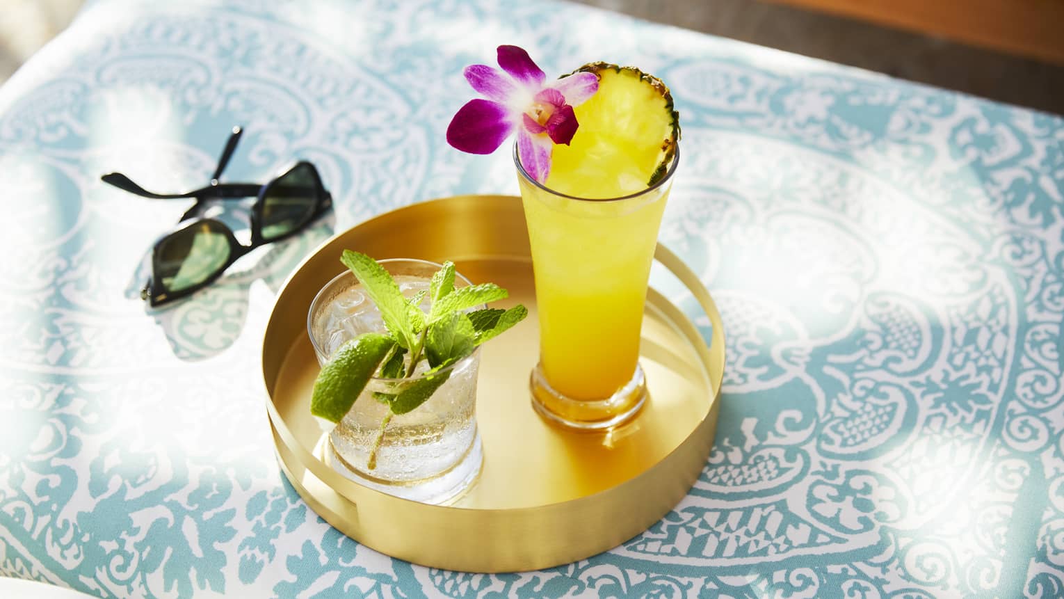 Tropical cocktails on a gold tray