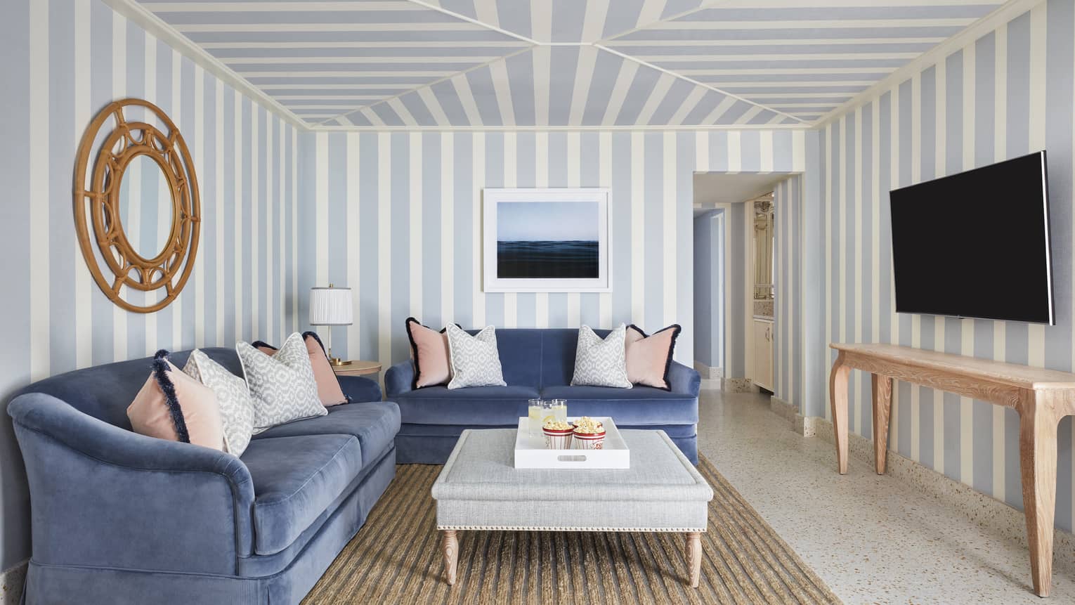 Living area of a Sea Breeze Suite, featuring two blue sofas and a coffee table