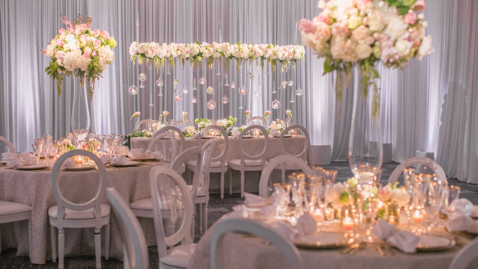 Flagler Ballroom wedding banquet with candle-lit tables, white flowers and glass bulb displays