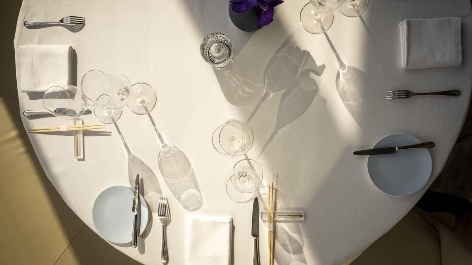 A large round table with table setting.