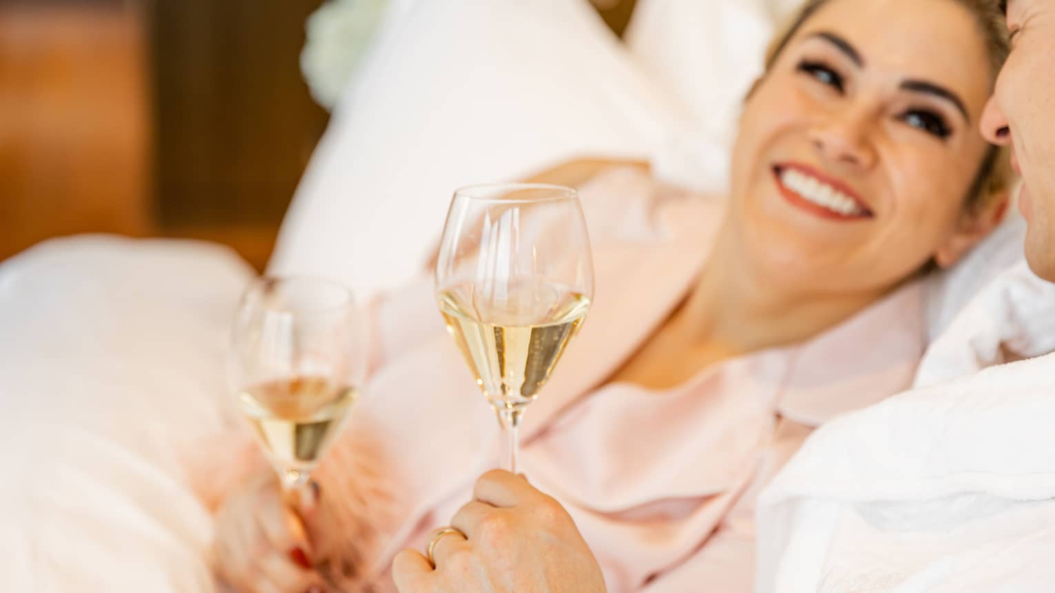 A woman and man resting with wine in hand.