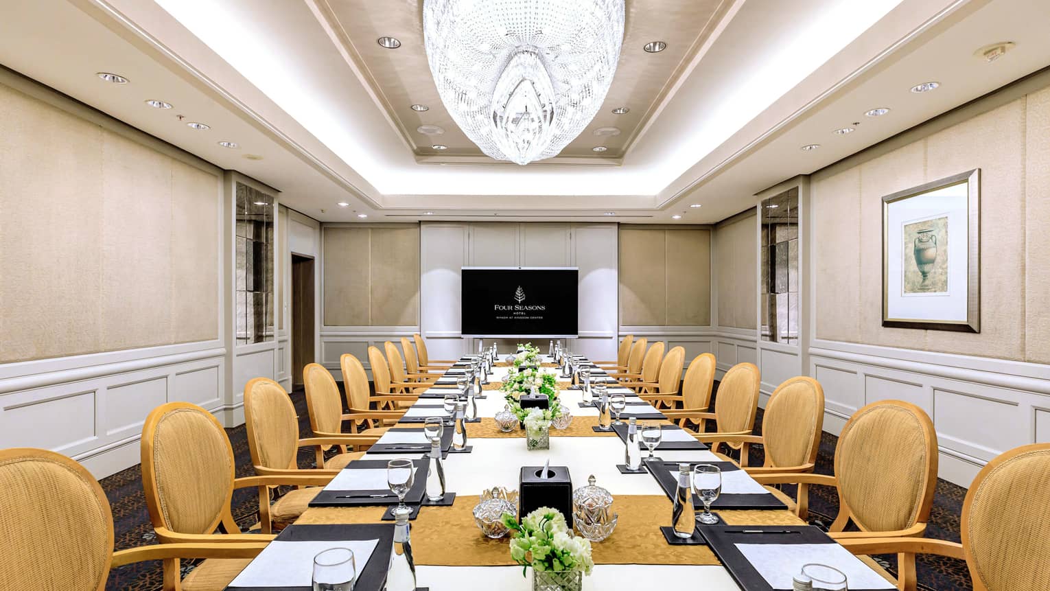 Elegant meeting room with crystal chandelier and board room seating