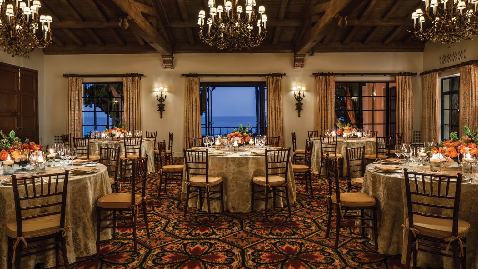 El Mar ballroom with round banquet tables under chandeliers, open patio doors