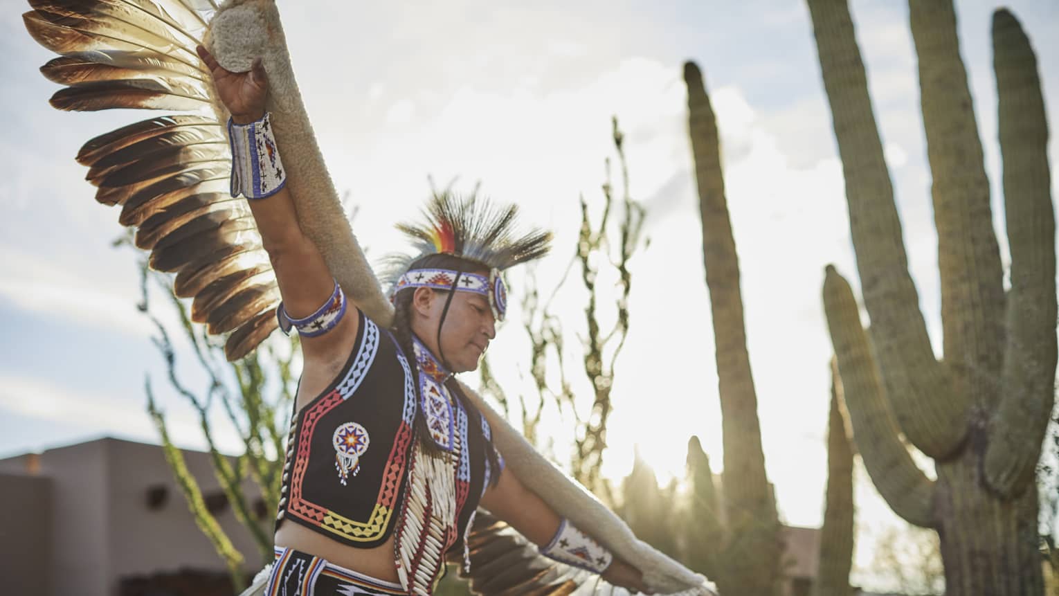 A man in indigenous clothes showing a cultural dance.