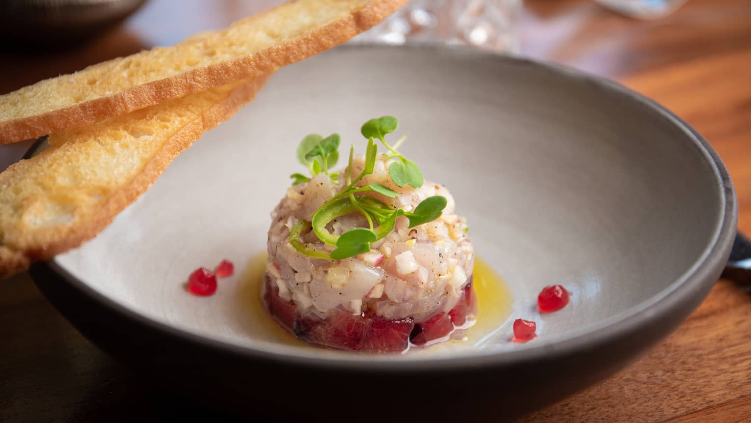 Fish ceviche in a grey bowl.