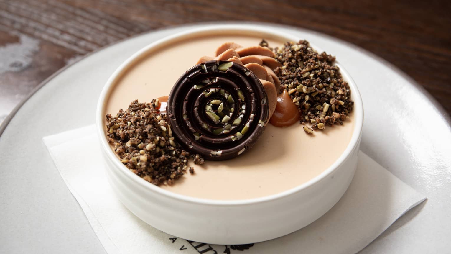 Pumpkin spice latte panna cotta in a white bowl.