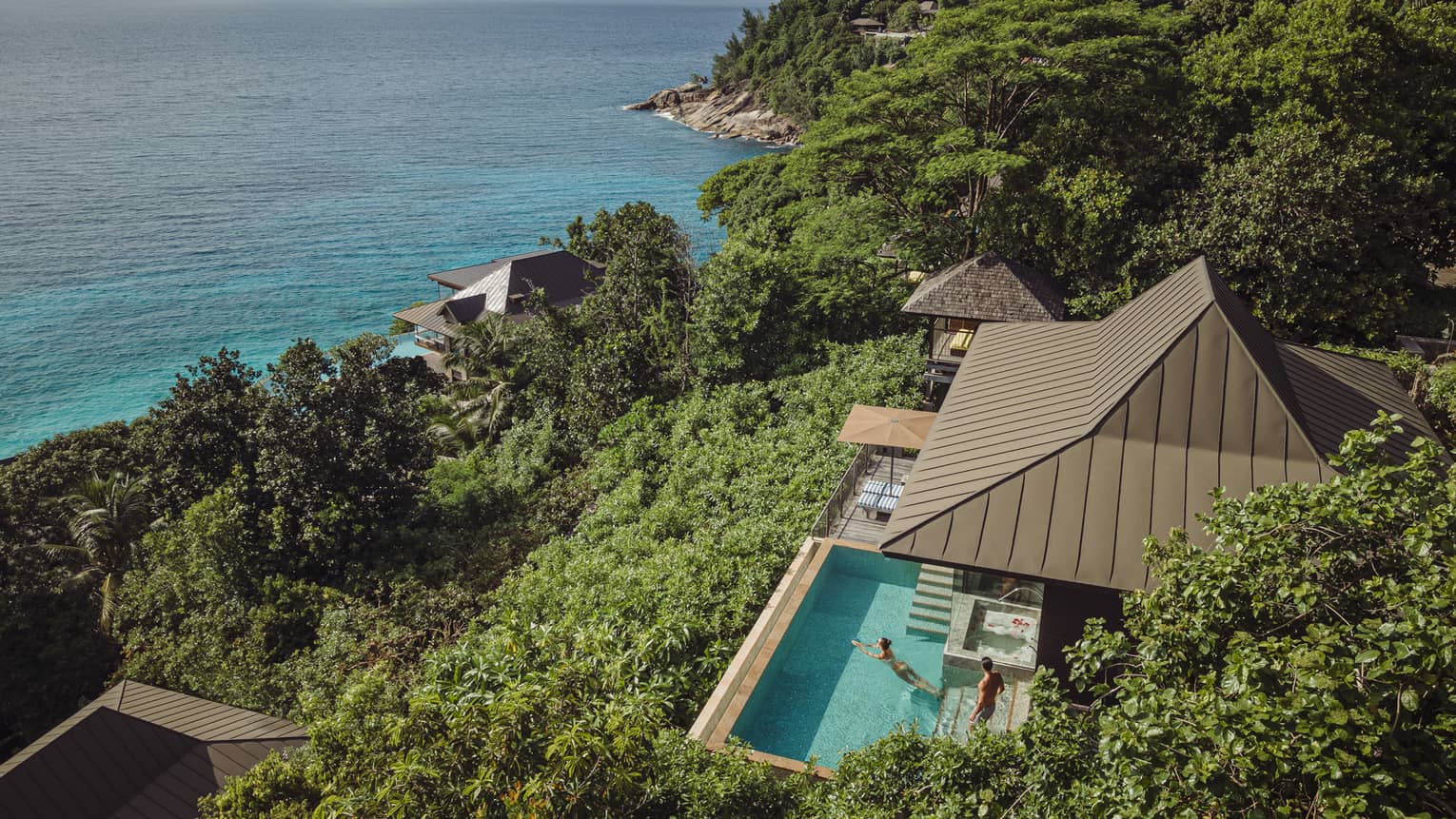 Aerial view of a Residence Villa at Four Seasons Resort Seychelles, overlooking turquoise ocean.