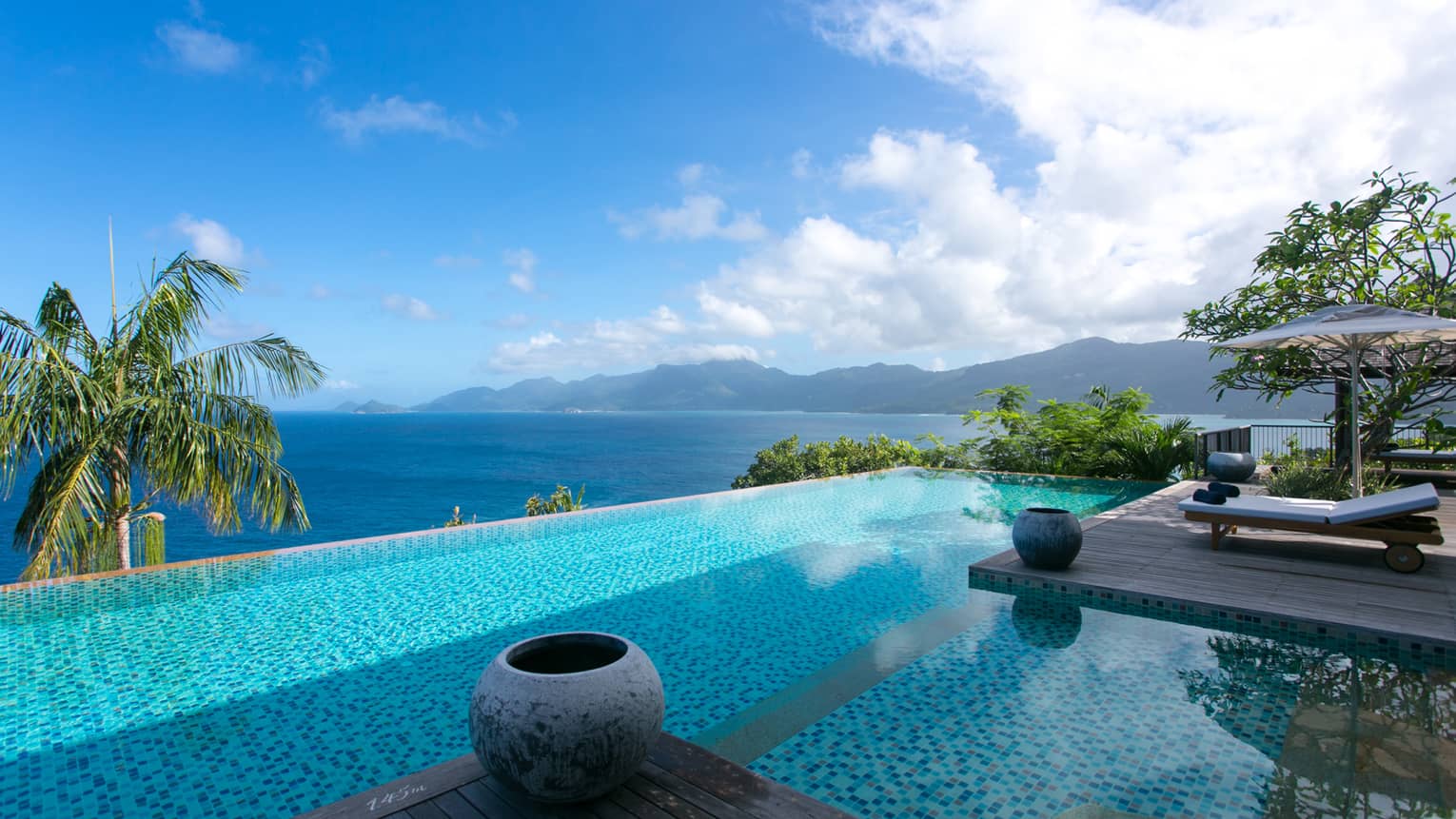 Six-Bedroom Residence Villa infinity pool beside top of palm tree, ocean view below