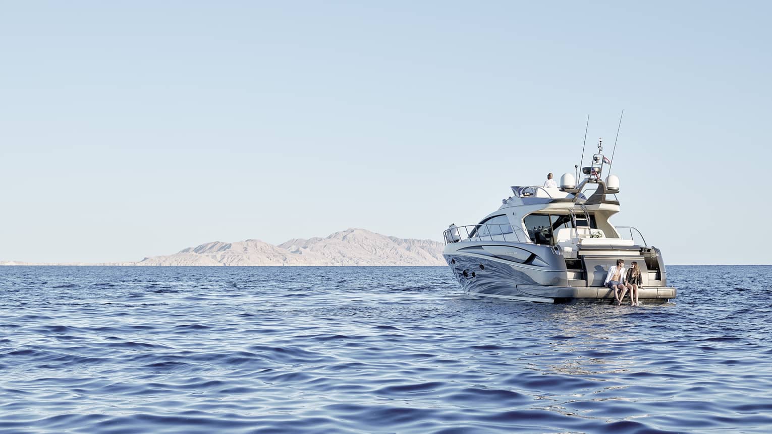 A couple on a luxury boat trip in the middle of the sea