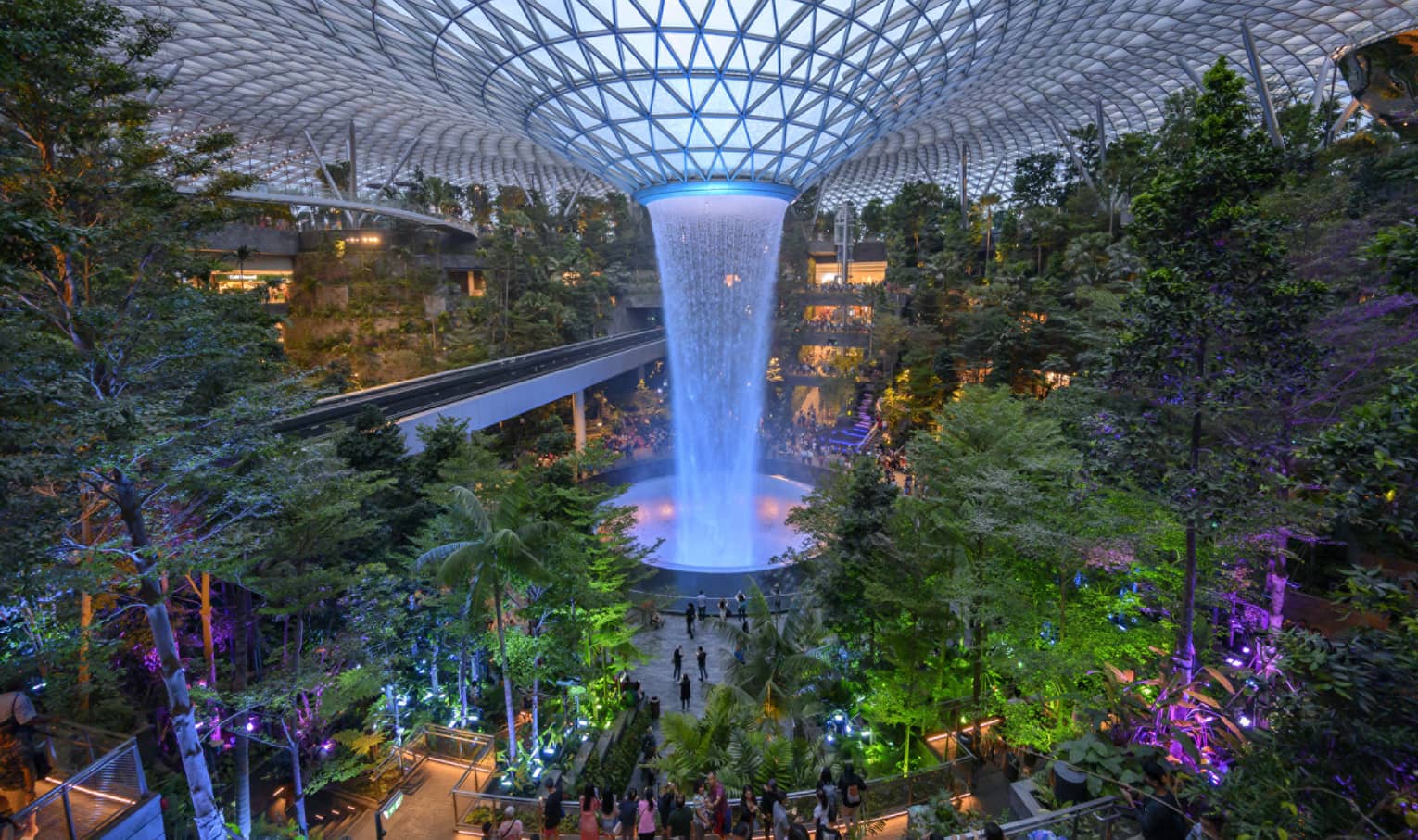 An arial view of an indoor garden with a large fountain in the center in singapore