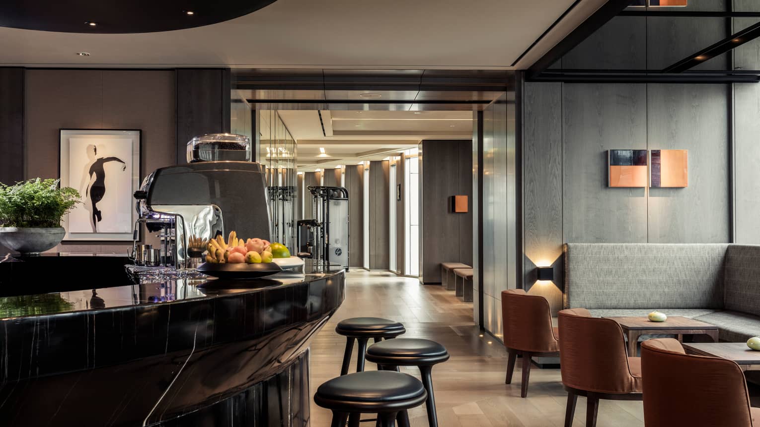 The Club black Juice Bar with stools in dimly-lit room