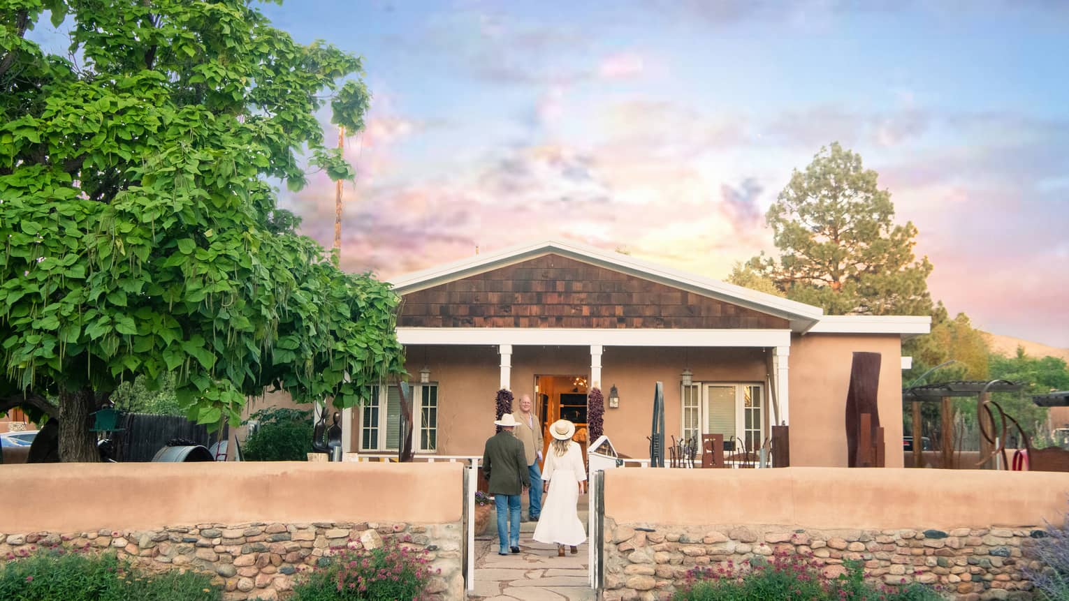 A man and woman walking up to a small building.