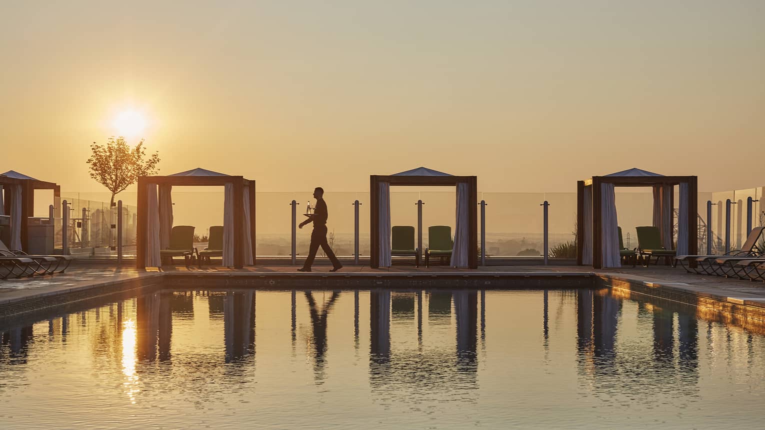 Poolside cabanas during sunset.
