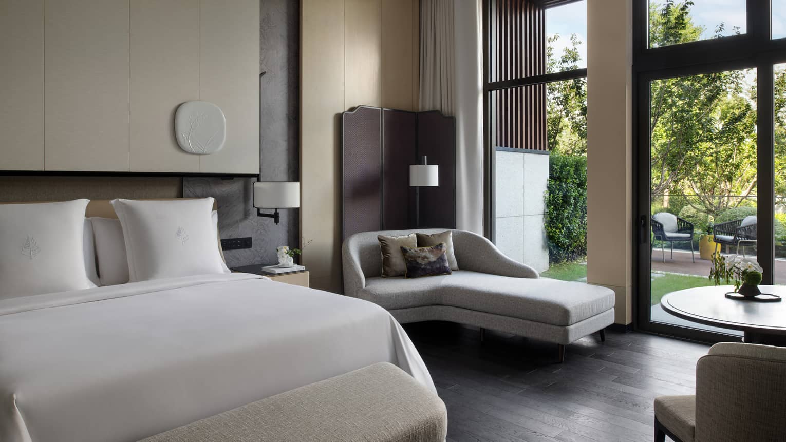 Luxury hotel room with king bed, chaise and garden terrace at Four Seasons Hotel Suzhou