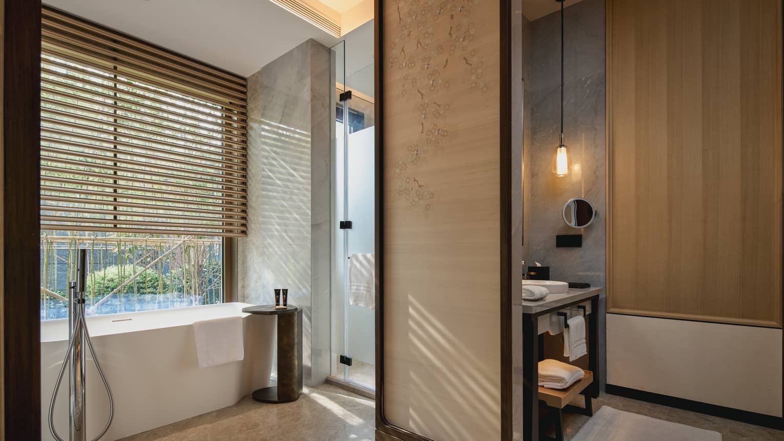 Modern bathroom with make-up vanity and standalone tub in a one-bedroom villa at Four Seasons Hotel Suzhou