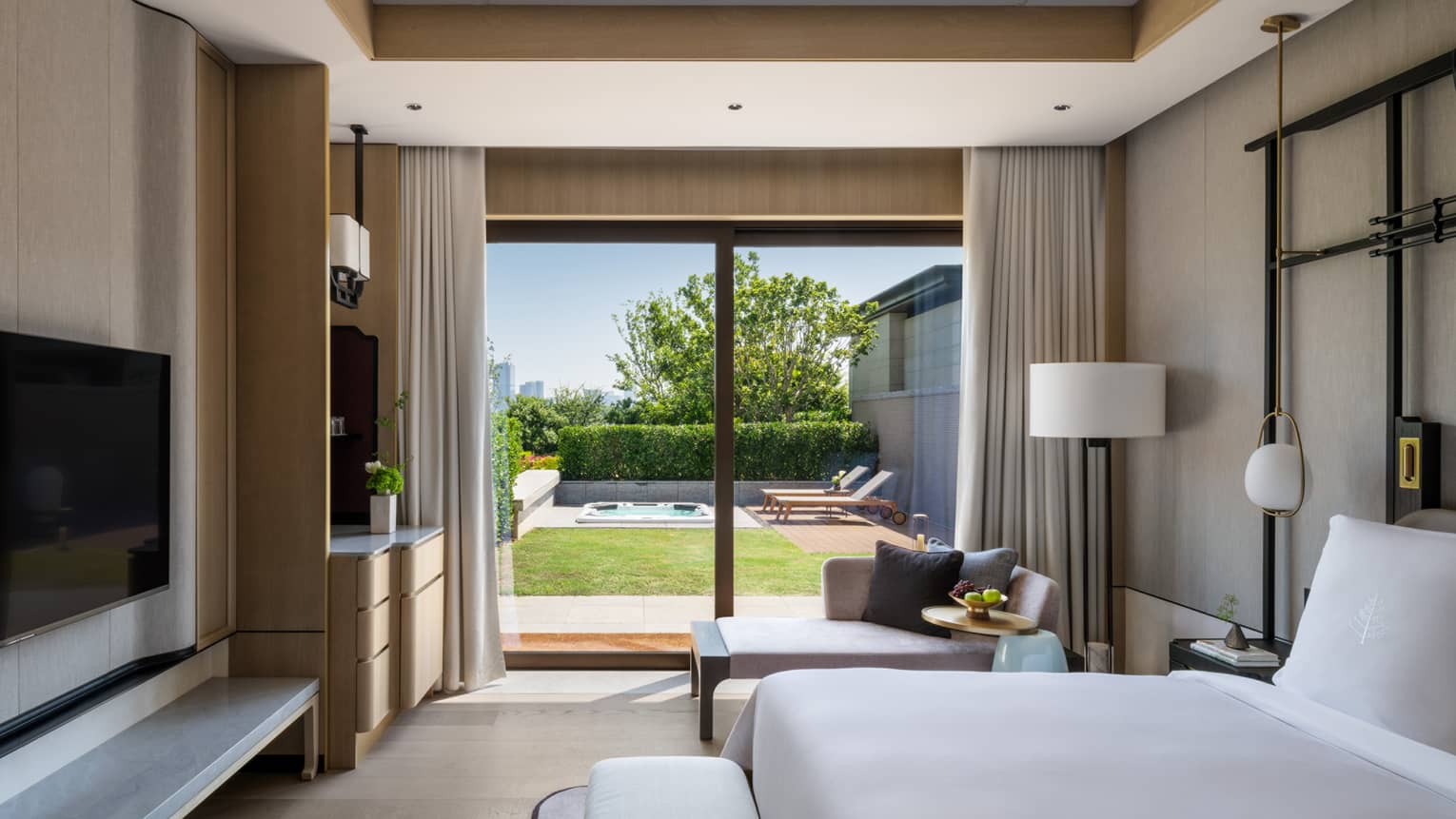 Sleek bedroom with king bed, TV and walk-out terrace at Four Seasons Hotel Suzhou