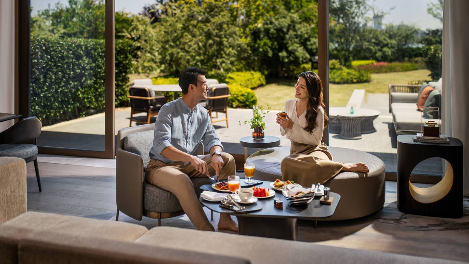 Man and woman enjoy In-Room Dining in luxury hotel villa at Four Seasons Hotel Suzhou, with private terrace