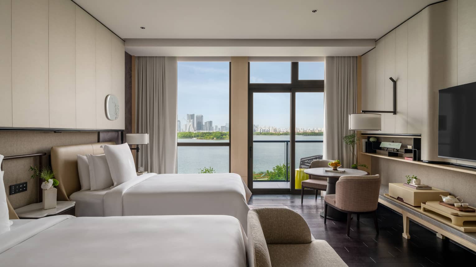 Luxury hotel room with two twin beds and lake view at Four Seasons Hotel Suzhou