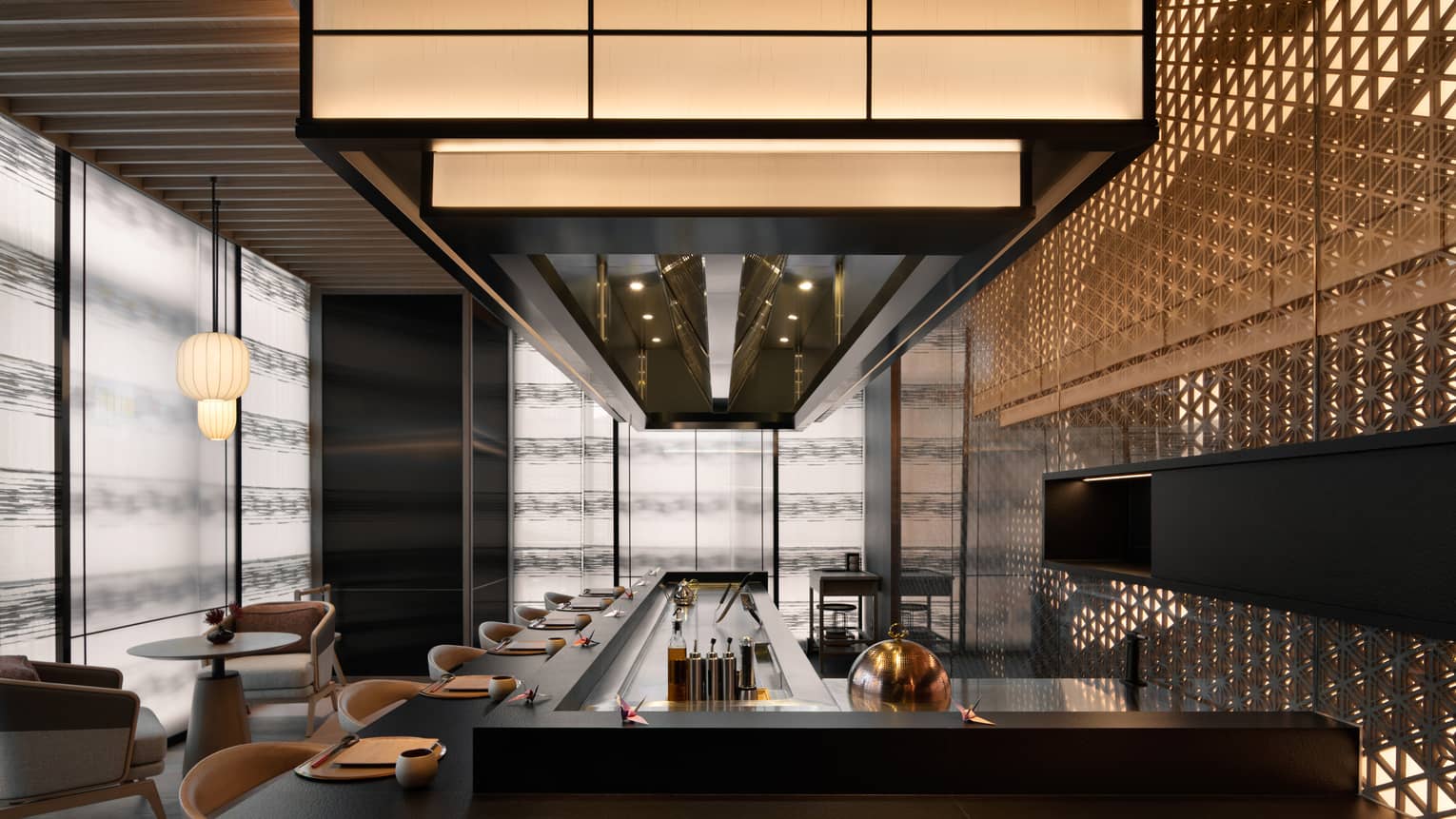 Bar area at Matsuyi with overhead lighting and rounded bar stools