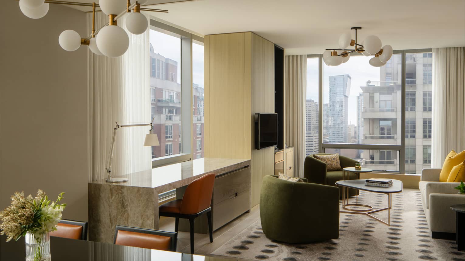 Hotel suite living room, desk and dining area at Four Seasons Hotel Toronto
