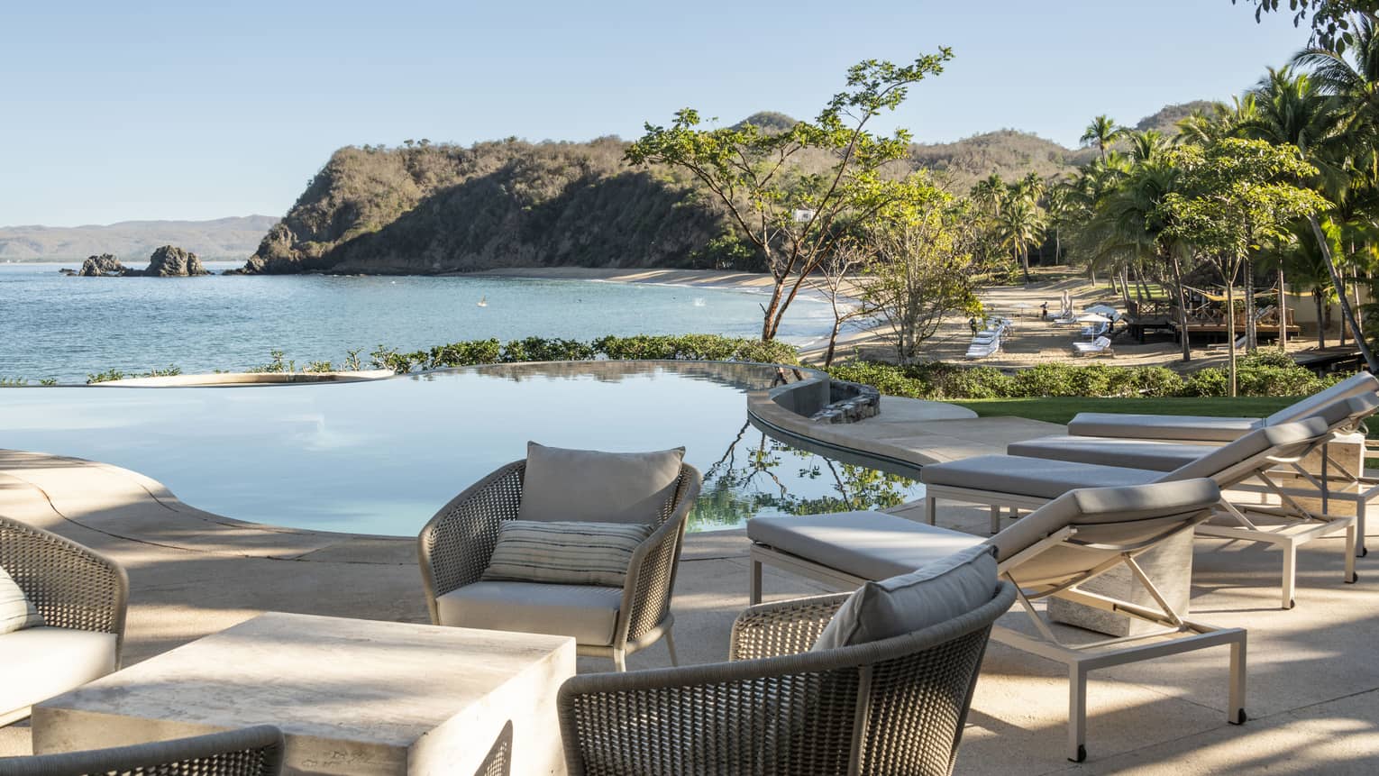 Private residence's chic outdoor lounge and pool terrace overlooking Tamarindo Beach at Four Seasons Resort Tamarindo