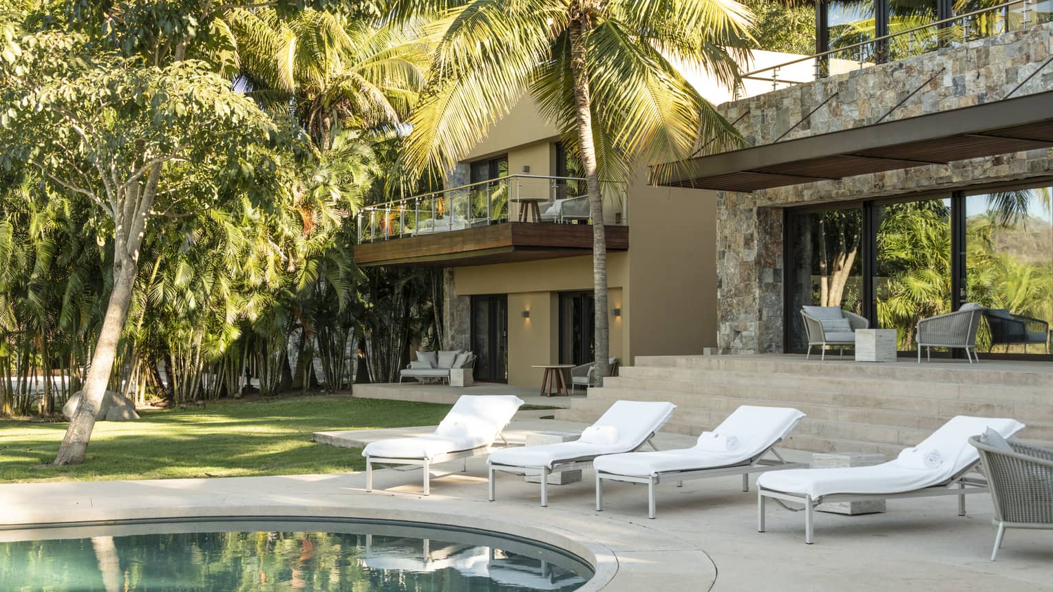 Private residence at Four Seasons Resort Tamarindo pool terrace with four lounge chairs
