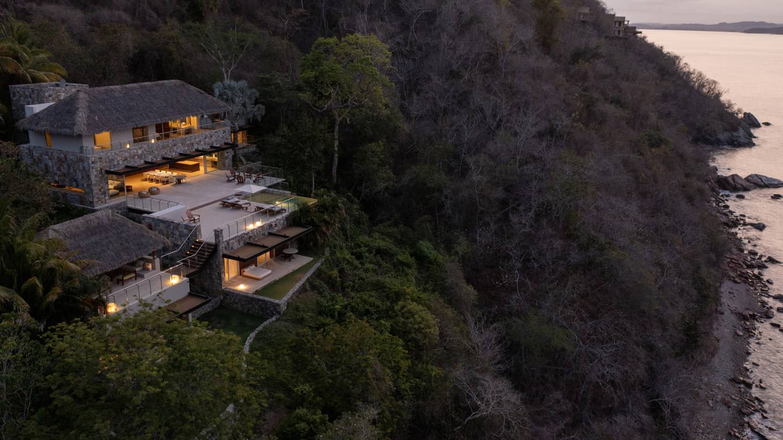 Exterior of Casa Piedra residence nestled into the cliffside overlooking Tamarindo Beach, at Four Seasons Resort Tamarindo, Mexico