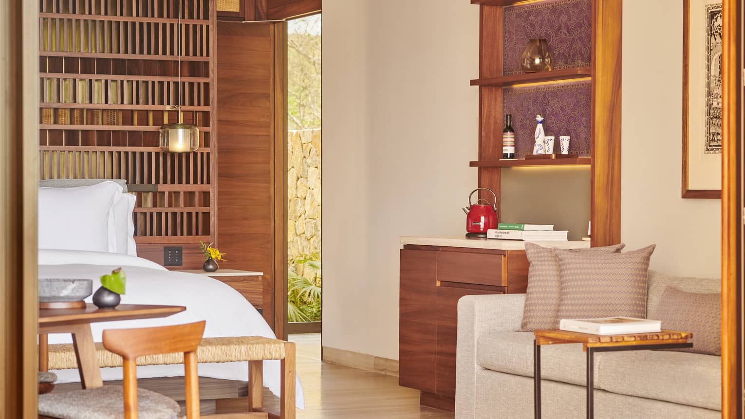 Hotel room with sofa, wet bar and king bed