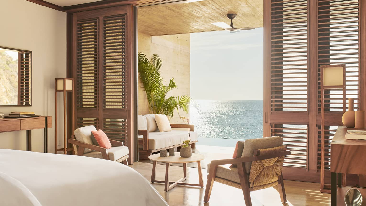 Resort bedroom opening to ocean-view terrace