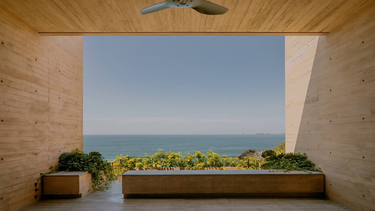 Covered modern terrace looking out to the ocean
