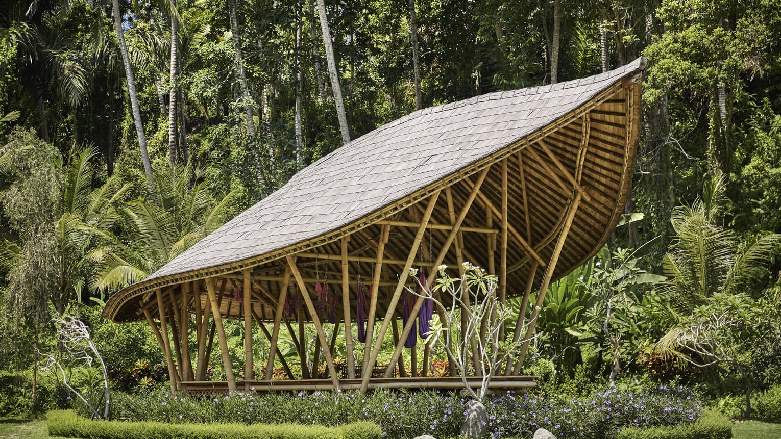Dharma Shanti Bale leaf-shaped pavilion in tropical garden