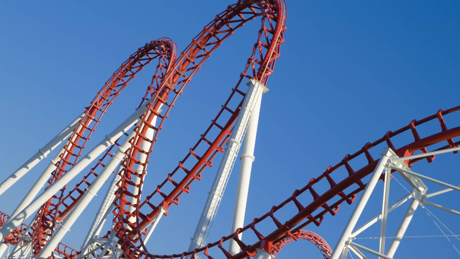 A white and red rollercoaster with two loops.