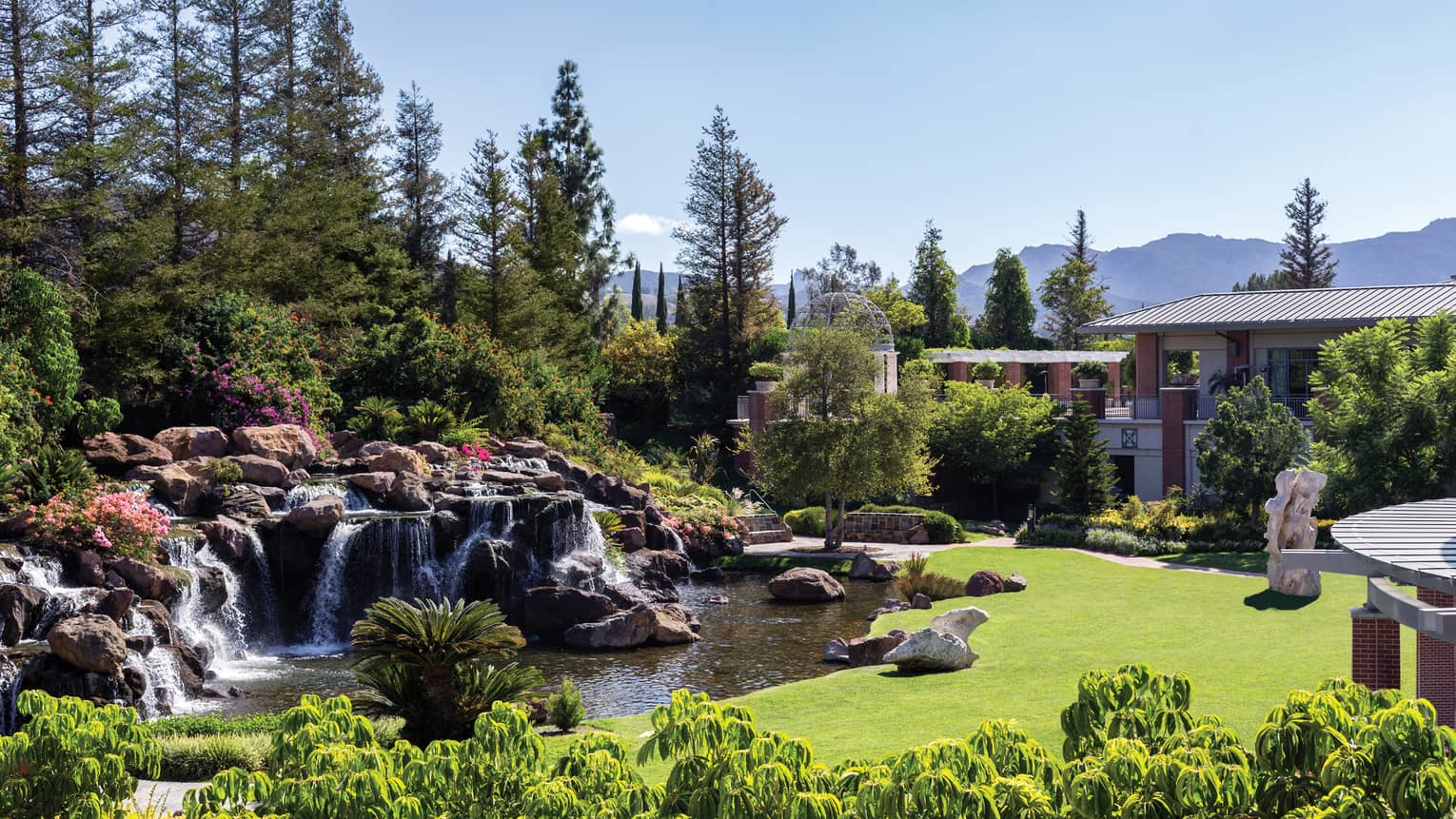 Waterfalls over rocks, boulders in garden at Four Seasons Hotel Westlake Village