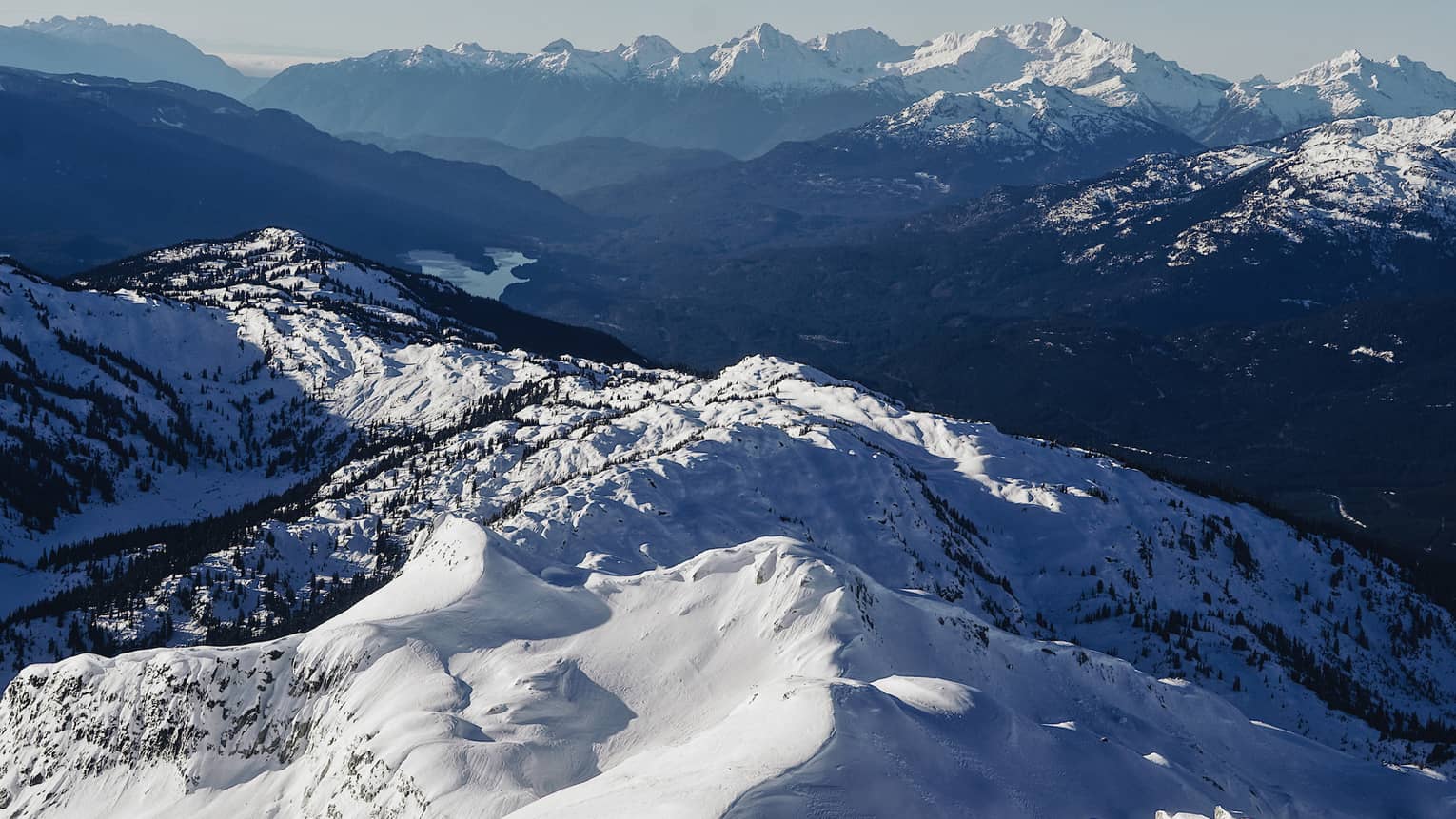 Summit view of snow-covered Coast Mountains