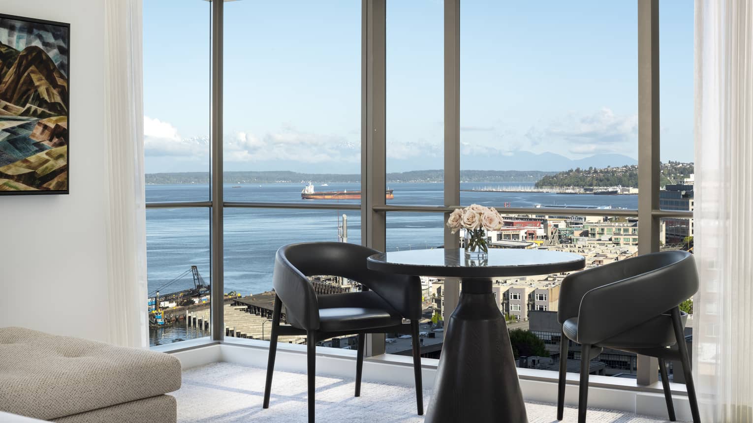 A table in the corner of the Prime Bay View Room overlooks the water and colorful buildings below