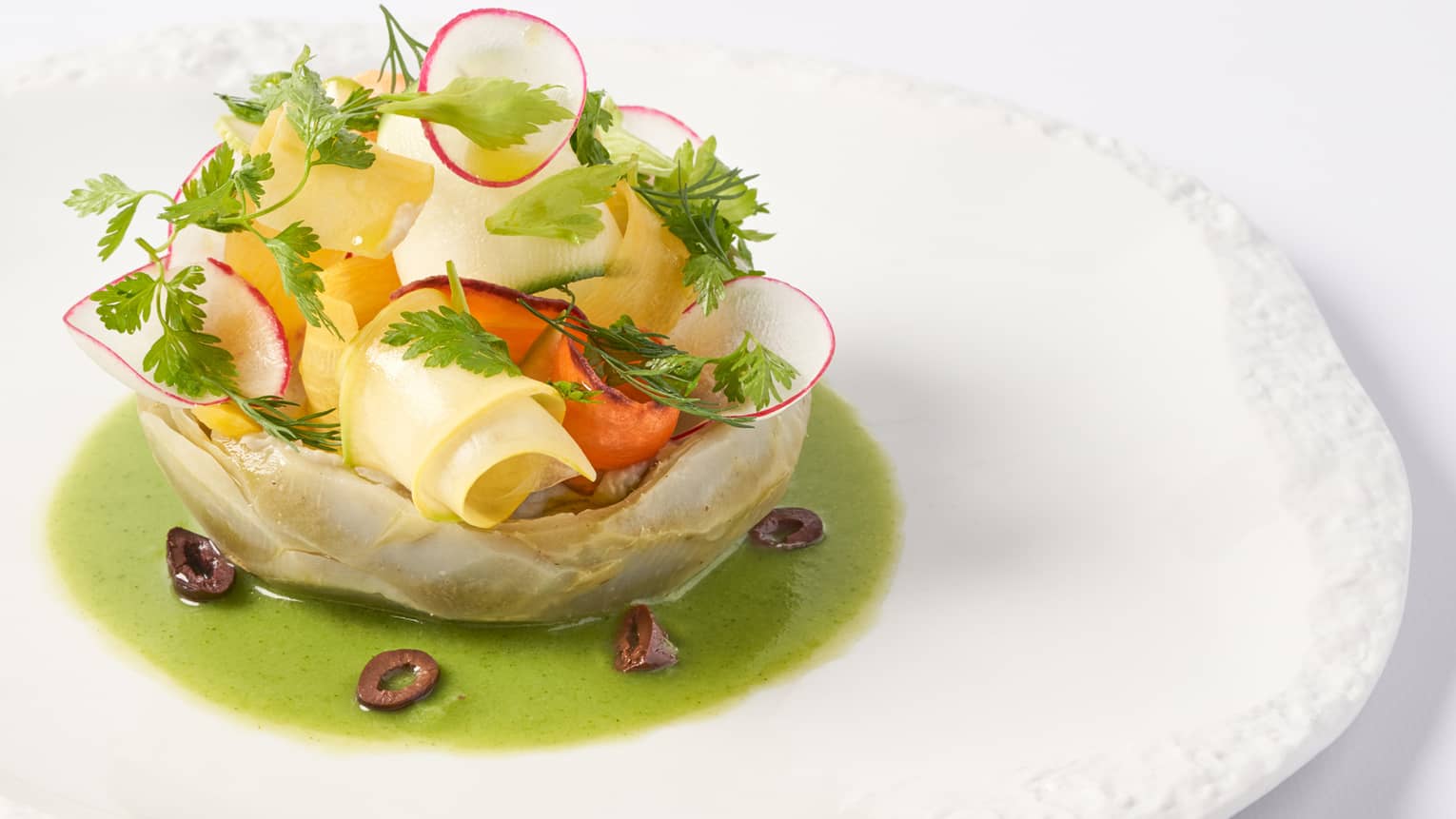  Camus artichokes in vinaigrette of young yegetables on white round plate