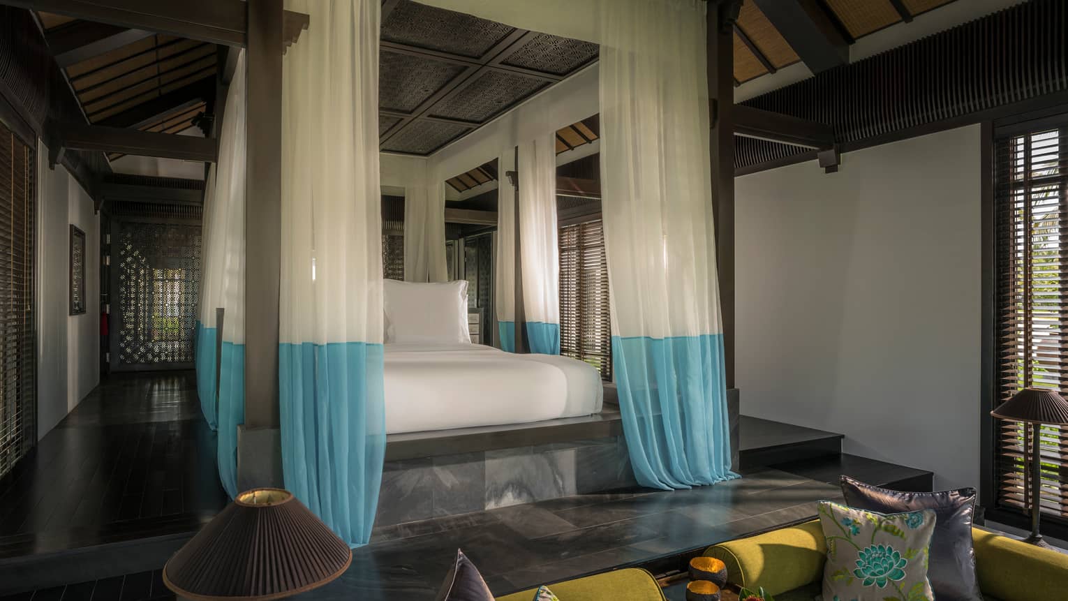 Villa raised platform poster bed with white-and-blue gossamer drape canopy