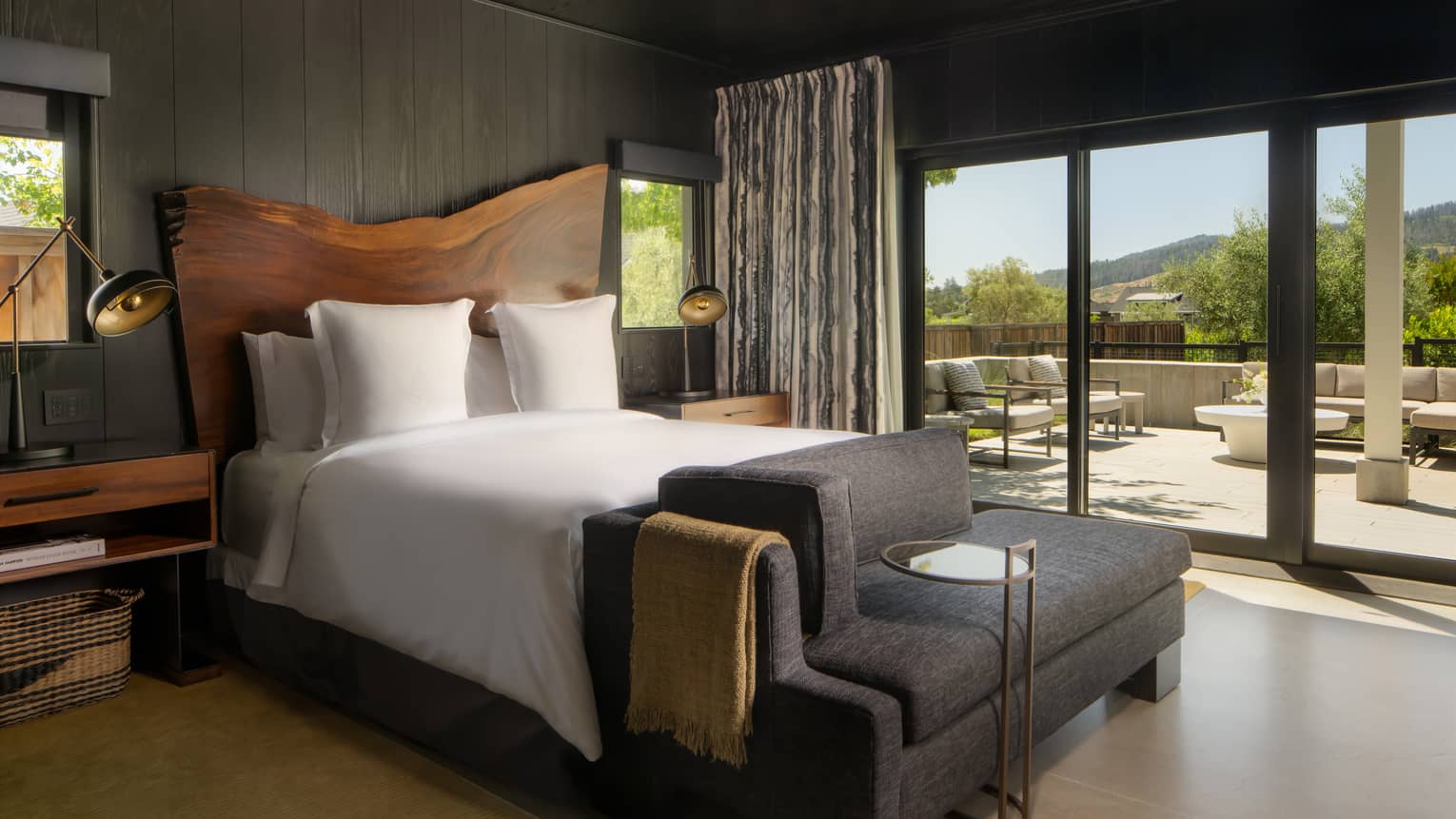 Contemporary bedroom featuring king bed and large, natural wood headboard
