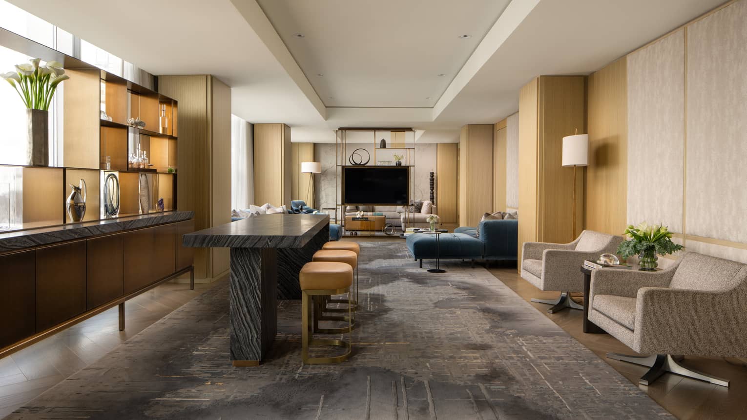Luxury suite with a black table with stools, stylish display shelf, TV, armchairs and blue sofa