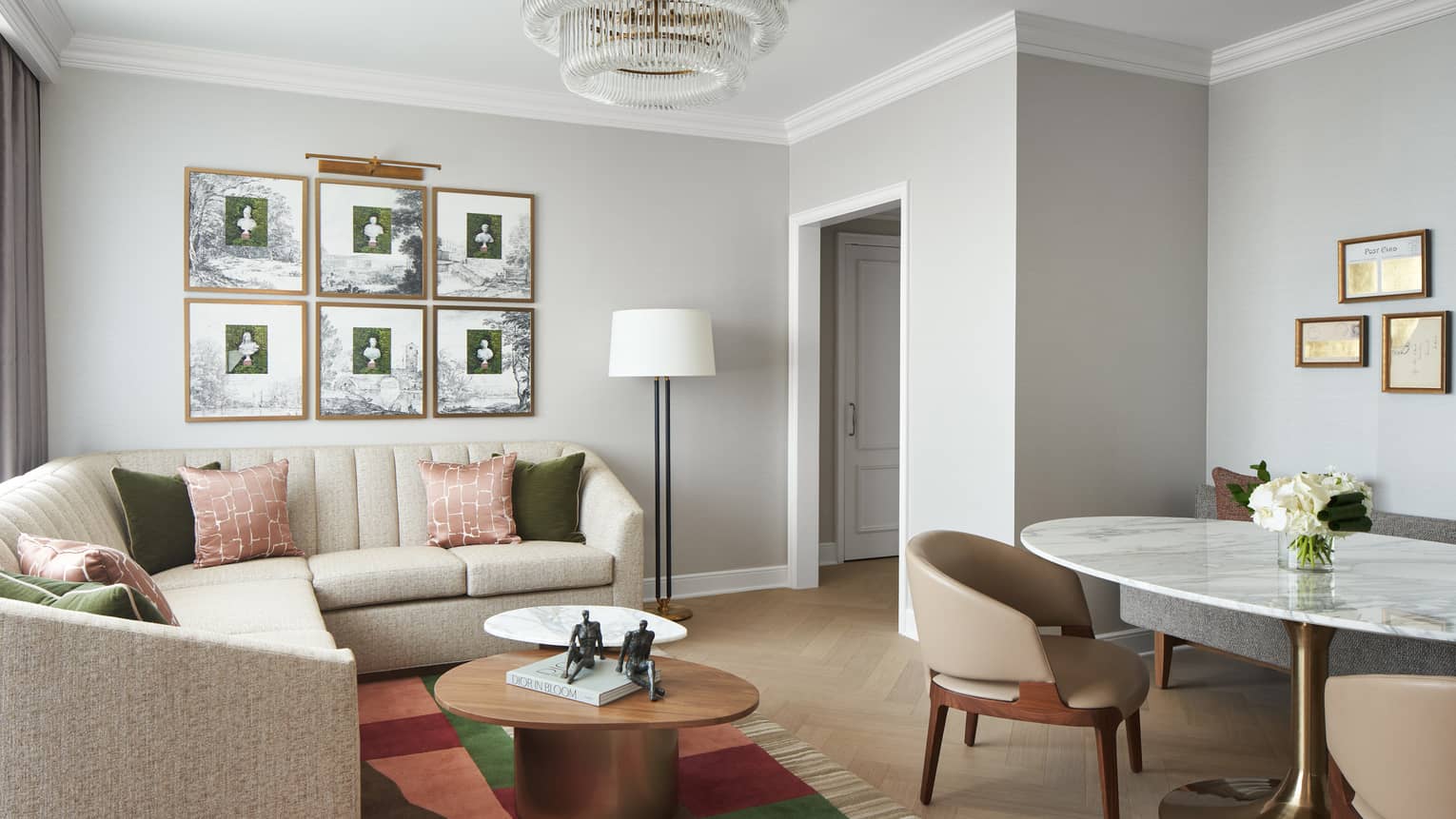 Chic living room of a Georgetown Suite, with sectional sofa and marble dining table, at Four Seasons Hotel Washington, DC
