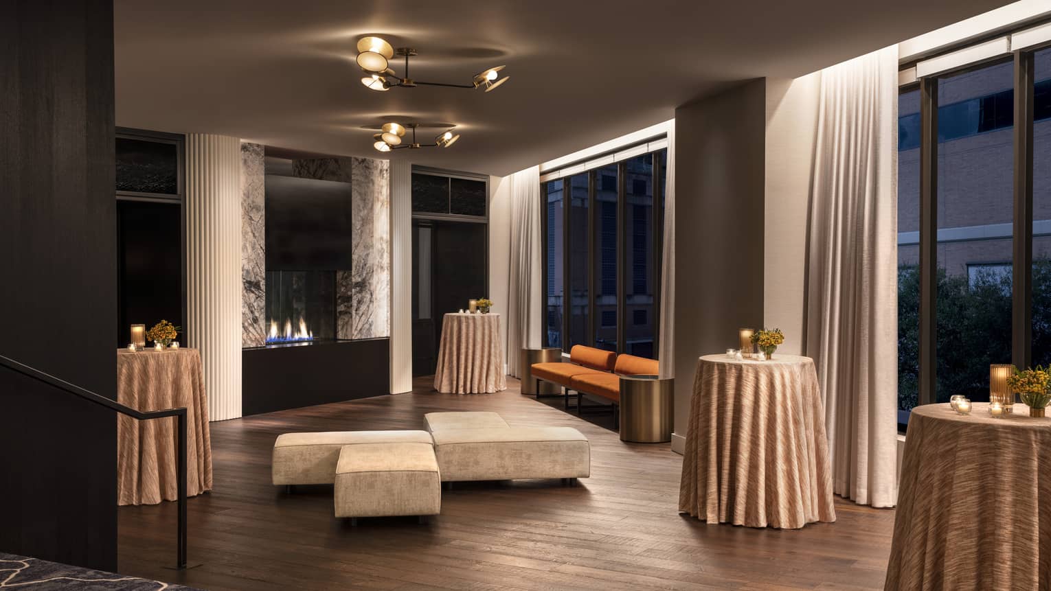 A room with small tables and seating areas.