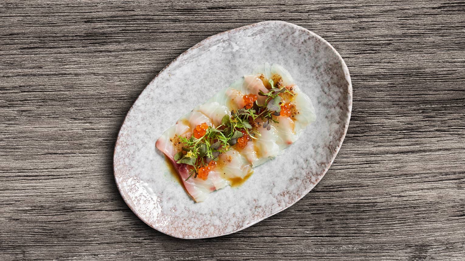 Raw fish with roe and herbs.