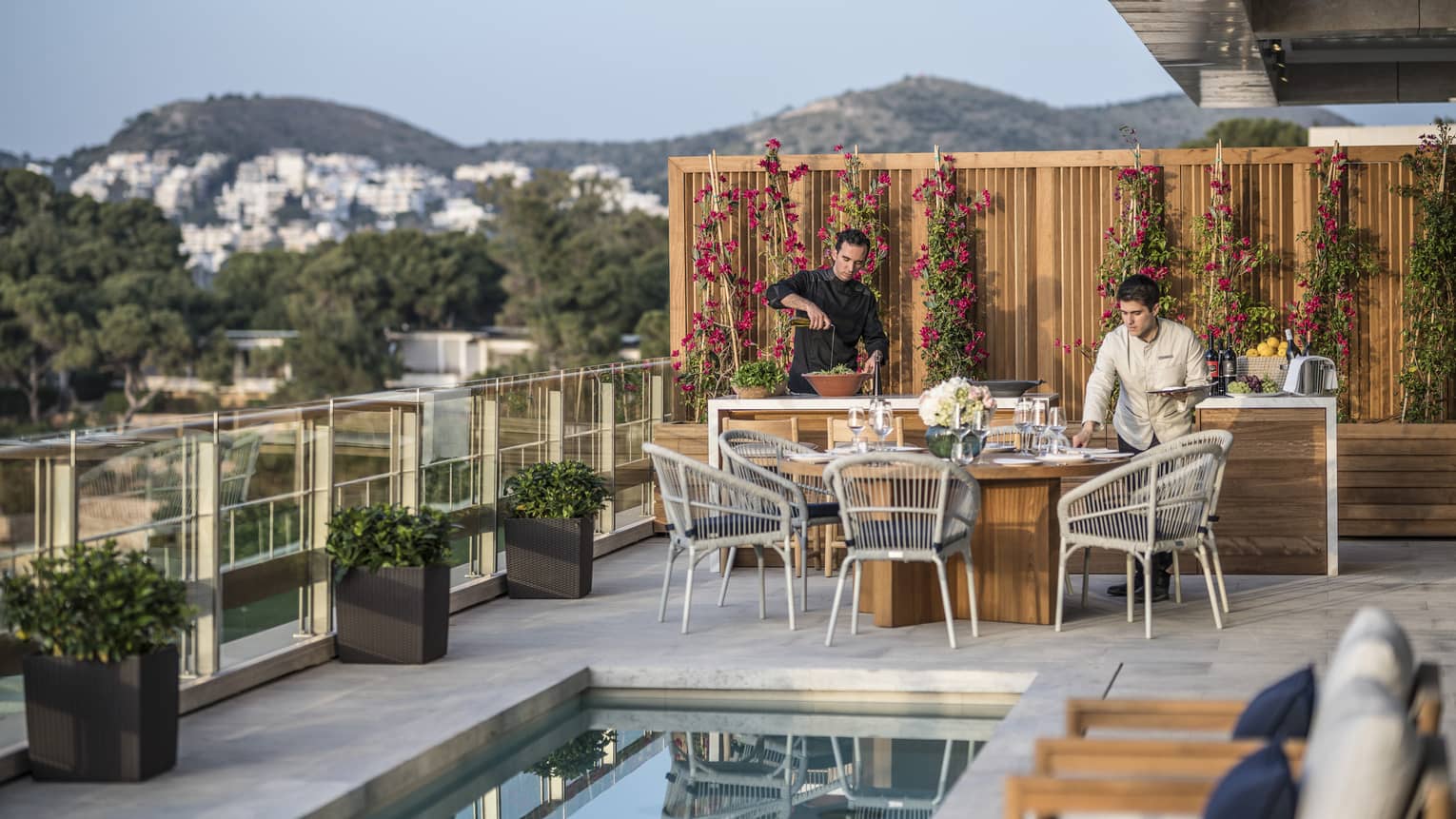 Arion Royal Suite Deck private dining, lap pool with row of lounge chairs, view of mountains and Crete in the background